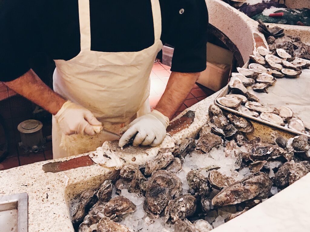 A man shucking oysters in a New Orleans restaurant.